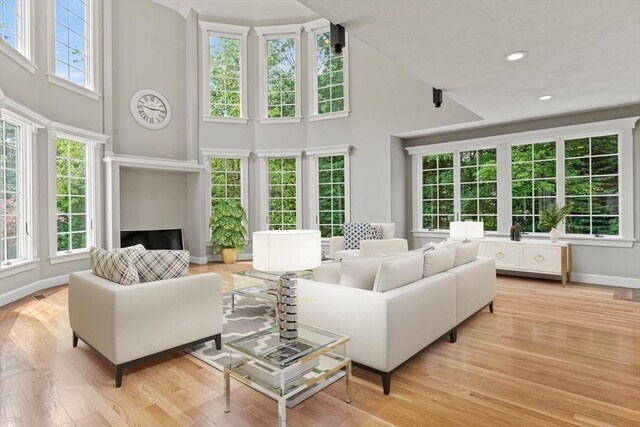 11 Ashford Ln, Andover, MA 01810 - living area featuring a towering ceiling, light wood-style floors, and recessed lighting