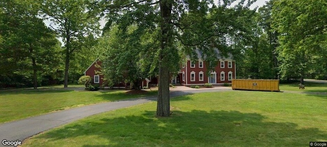 view of property's community with a yard and a jacuzzi