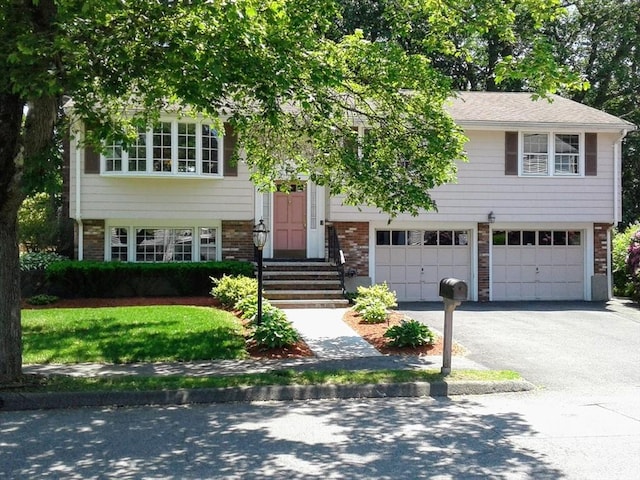 22 Susan Dr, Saugus, MA 01906 - raised ranch featuring an attached garage, brick siding, and driveway