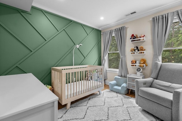 34 Colgate Rd Unit 3, Boston, MA 02131 - bedroom with crown molding, multiple windows, a crib, a decorative wall, and recessed lighting