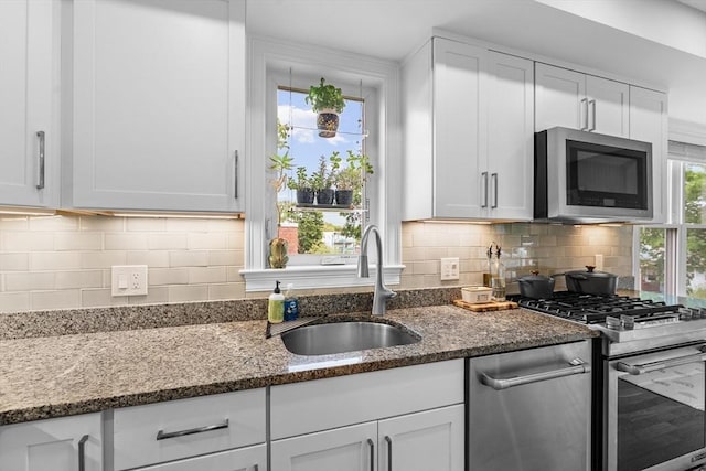 34 Colgate Rd Unit 3, Boston, MA 02131 - kitchen featuring a sink, appliances with stainless steel finishes, white cabinetry, and dark stone countertops