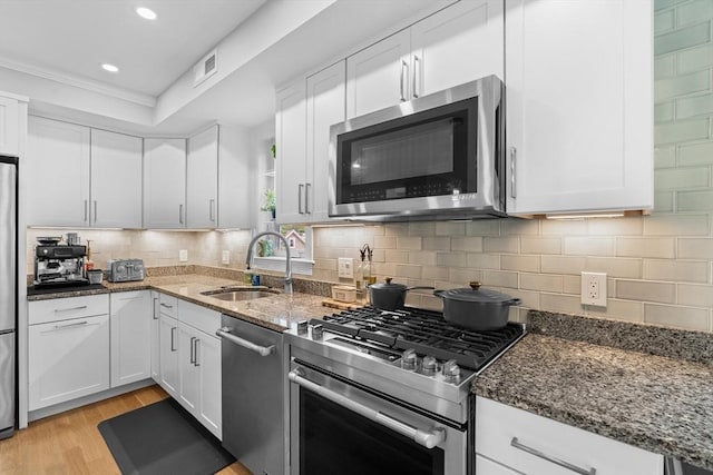 34 Colgate Rd Unit 3, Boston, MA 02131 - kitchen featuring stainless steel appliances, a sink, dark stone countertops, white cabinets, and recessed lighting