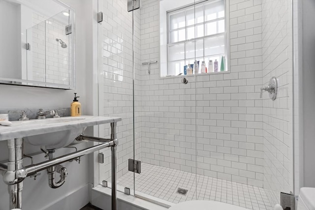 full bathroom with a stall shower and toilet