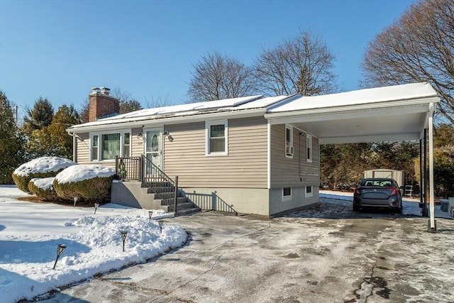 view of front of home with a carport