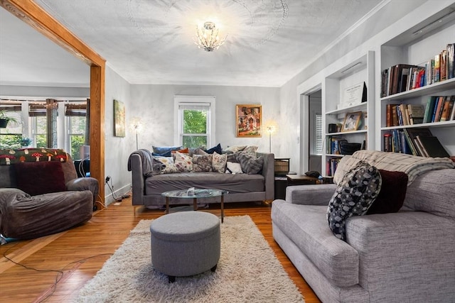 466 Lincoln St, Marlborough, MA 01752 - living area with wood finished floors, a chandelier, and built in features