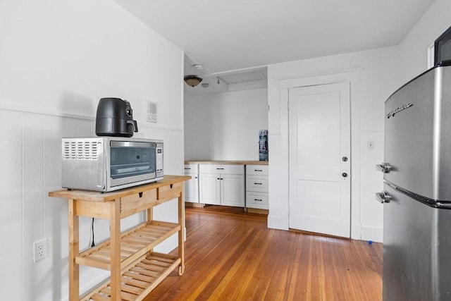 466 Lincoln St, Marlborough, MA 01752 - kitchen with freestanding refrigerator, white cabinets, dark wood-style floors, and light countertops