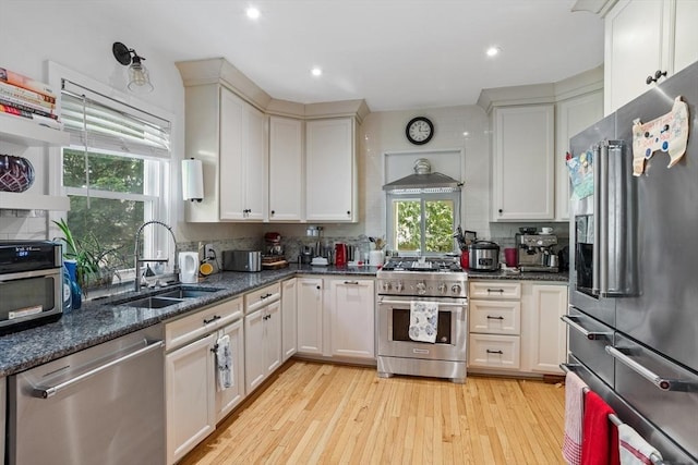 466 Lincoln St, Marlborough, MA 01752 - kitchen with stainless steel appliances, a sink, decorative backsplash, light wood-style flooring, and recessed lighting