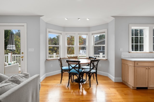 dining space with light hardwood / wood-style floors and plenty of natural light