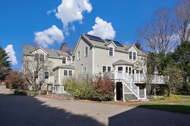 back of house with a wooden deck