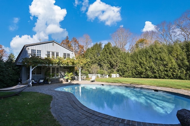 view of swimming pool with a patio area and a lawn