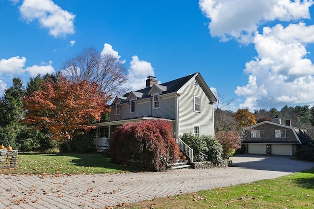 view of front of home with a front yard and a garage