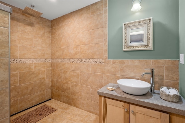 bathroom featuring tile walls, vanity, and tiled shower