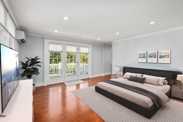 bedroom featuring ornamental molding, a wall mounted AC, access to exterior, and wood-type flooring