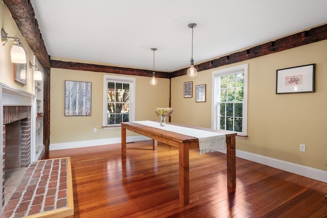 game room with hardwood / wood-style flooring and a fireplace