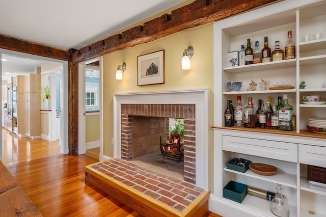 interior space with light hardwood / wood-style flooring, plenty of natural light, and a fireplace