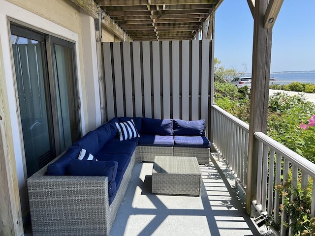 balcony featuring a water view and outdoor lounge area