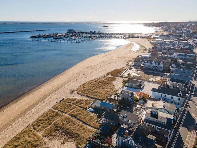 birds eye view of property featuring a beach view and a water view