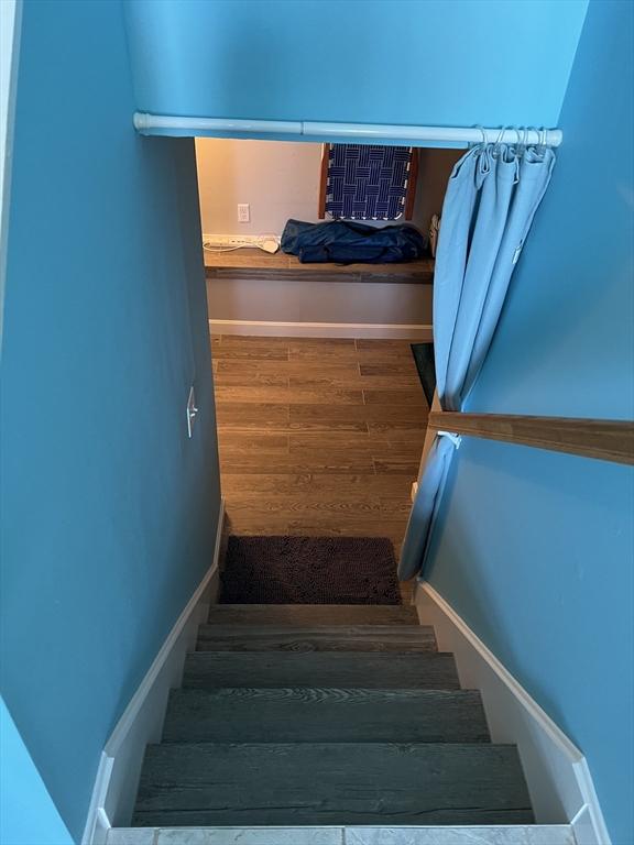 staircase featuring hardwood / wood-style flooring