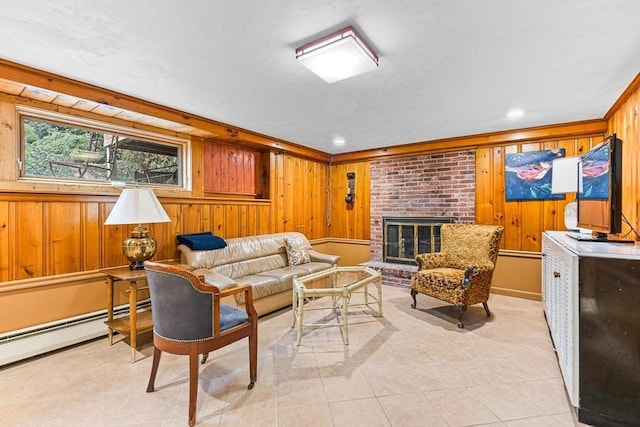 living room with light tile patterned flooring, a brick fireplace, baseboard heating, ornamental molding, and wooden walls