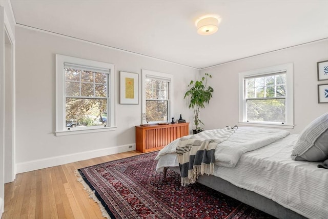 bedroom with baseboards and hardwood / wood-style floors