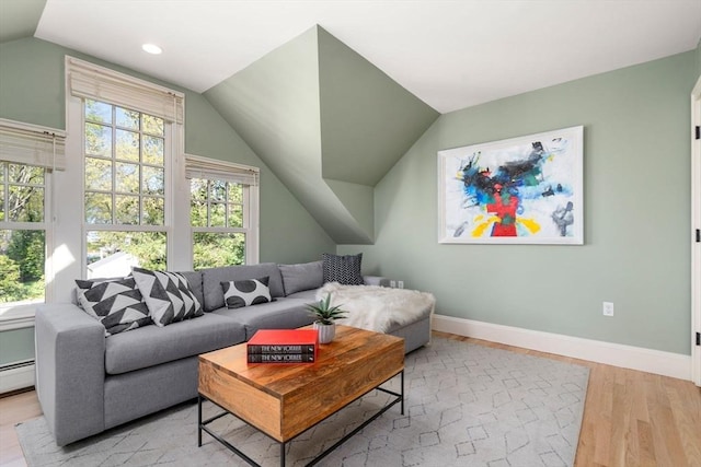 living room featuring baseboards, recessed lighting, wood finished floors, and lofted ceiling
