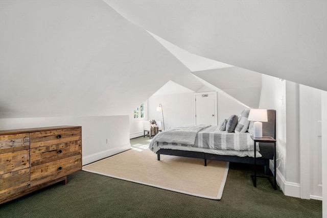 carpeted bedroom featuring baseboards and lofted ceiling