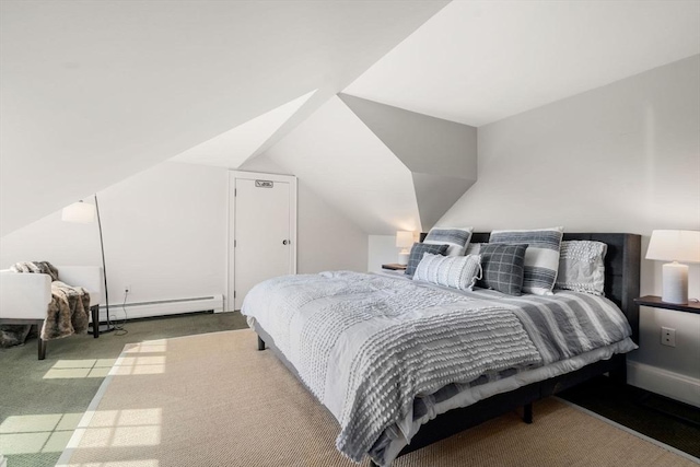 carpeted bedroom with a baseboard heating unit and vaulted ceiling