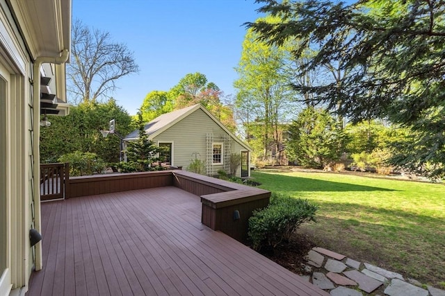 wooden deck featuring a lawn