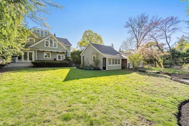 exterior space with fence, an outdoor structure, and a yard