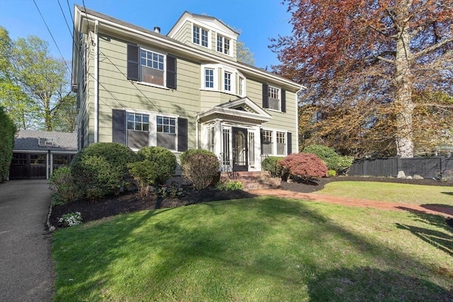 view of front facade with fence and a front yard