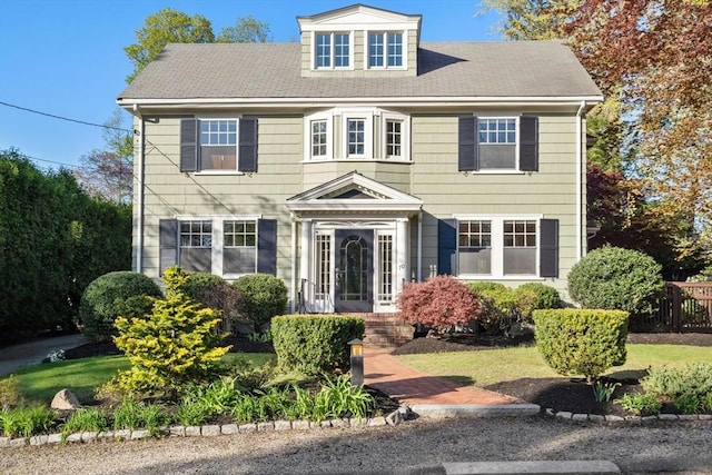 view of front of home featuring fence