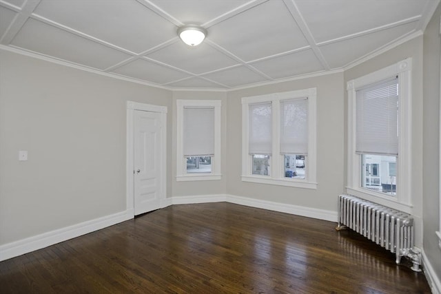 spare room featuring radiator, dark wood-type flooring, and coffered ceiling