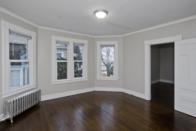 empty room featuring radiator heating unit, crown molding, and dark wood-type flooring