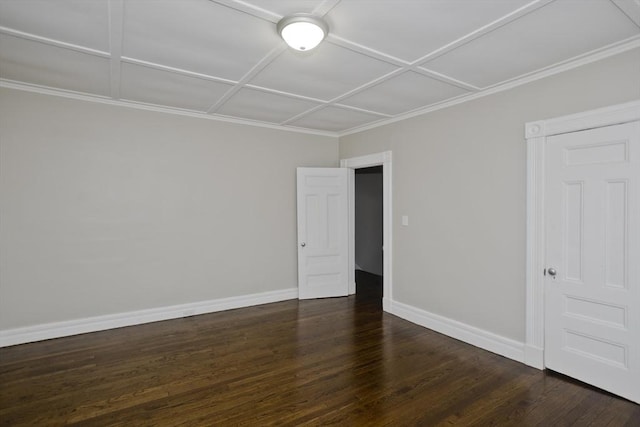 empty room with dark wood-type flooring and coffered ceiling