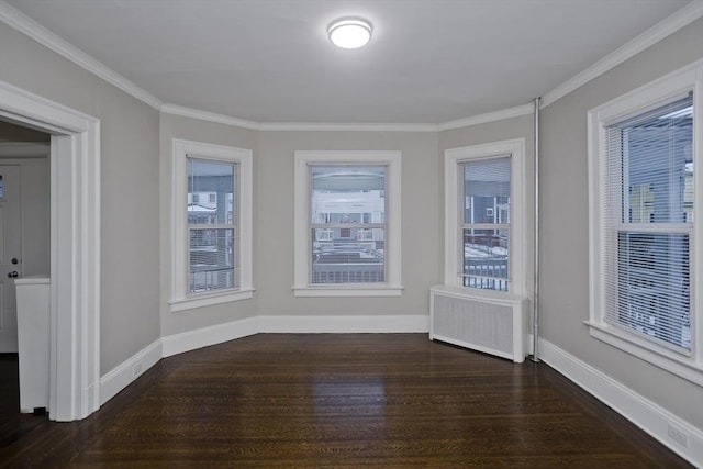 empty room with dark wood-type flooring, radiator, and ornamental molding