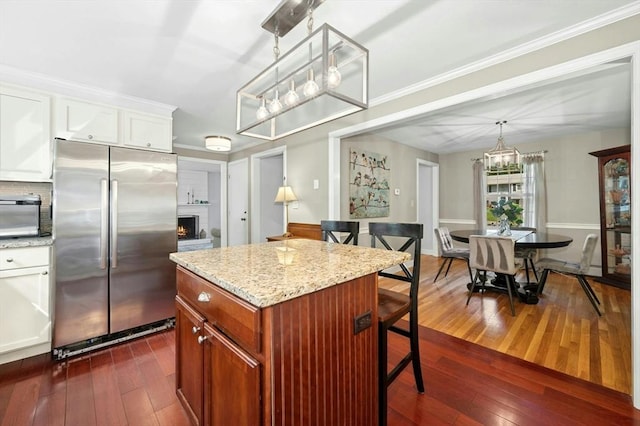 30 Eastview Rd, Hopkinton, MA 01748 - kitchen featuring freestanding refrigerator, a chandelier, dark wood finished floors, white cabinetry, and a kitchen bar