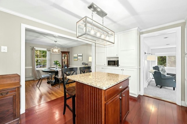 30 Eastview Rd, Hopkinton, MA 01748 - kitchen with stainless steel microwave, white cabinets, dark wood-type flooring, light stone counters, and pendant lighting