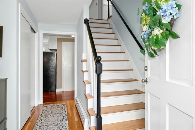 30 Eastview Rd, Hopkinton, MA 01748 - stairway featuring wood finished floors and a baseboard heating unit
