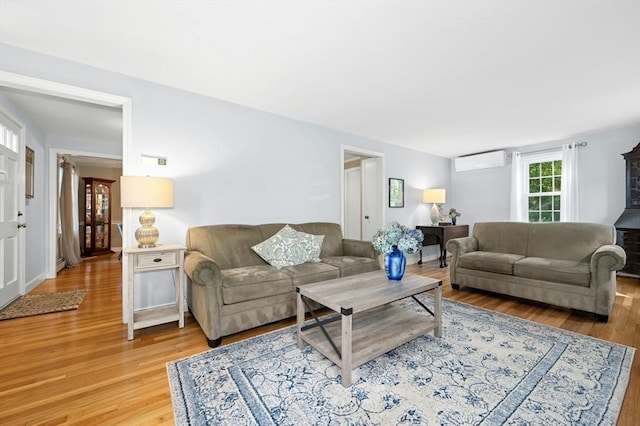 30 Eastview Rd, Hopkinton, MA 01748 - living room featuring an AC wall unit and light wood finished floors