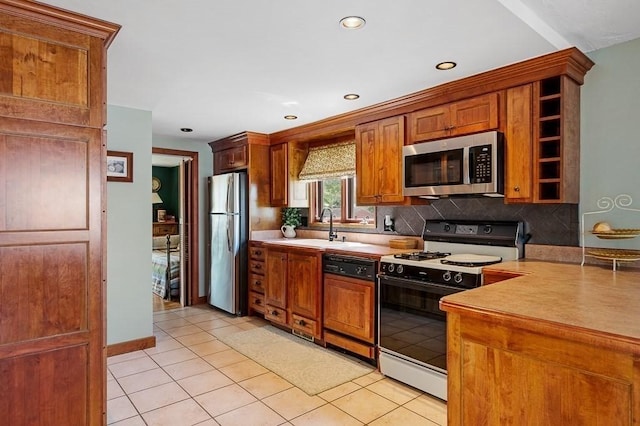 45 Point Pleasant Rd, Webster, MA 01570 - kitchen with appliances with stainless steel finishes, open shelves, backsplash, light countertops, and light tile patterned flooring