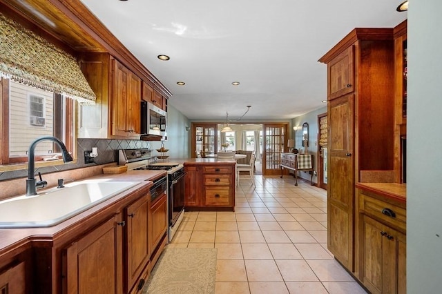 45 Point Pleasant Rd, Webster, MA 01570 - kitchen with white range with gas stovetop, stainless steel microwave, a peninsula, recessed lighting, and light tile patterned floors