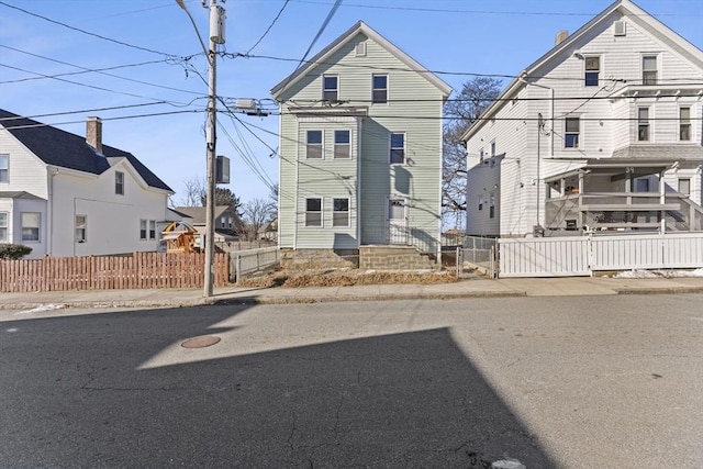 view of front of property featuring fence