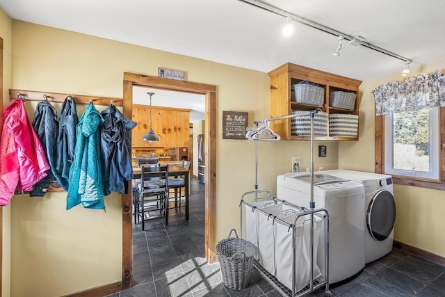 washroom featuring laundry area, independent washer and dryer, and baseboards