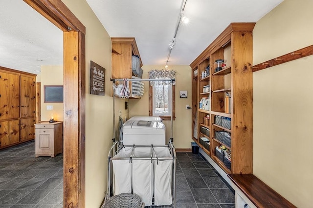 washroom featuring laundry area and track lighting