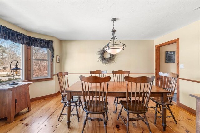 dining room featuring light wood-type flooring and baseboards