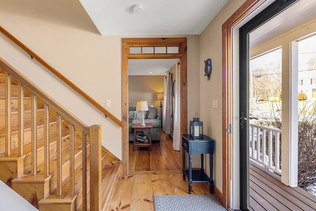 entryway with light wood finished floors and stairs