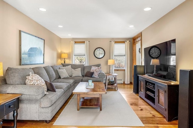 living area with light wood-type flooring and recessed lighting