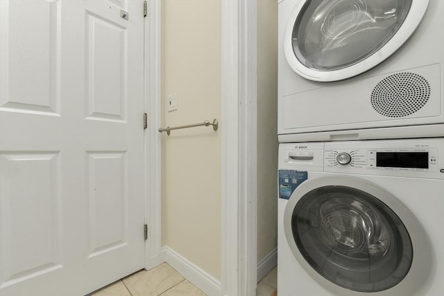 16 Emerson St Unit 1, Boston, MA 02127 - laundry area with stacked washer / dryer and light tile patterned floors