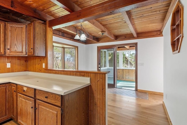 kitchen with beamed ceiling, wooden ceiling, and a wealth of natural light
