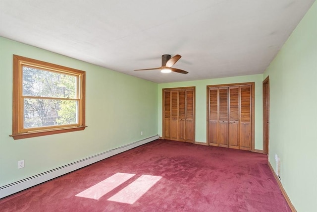 unfurnished bedroom with carpet flooring, ceiling fan, multiple closets, baseboards, and a baseboard radiator